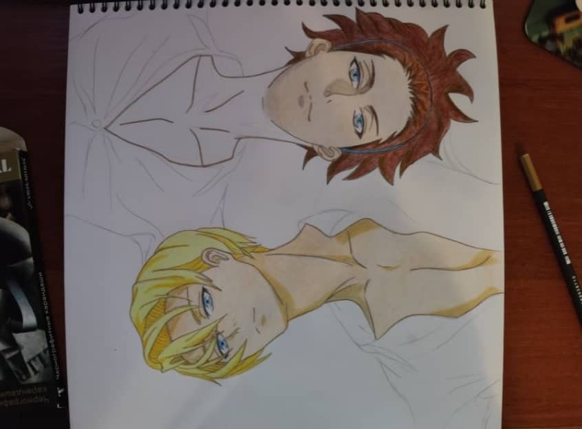 Drawing of two male anime characters on a notepad.